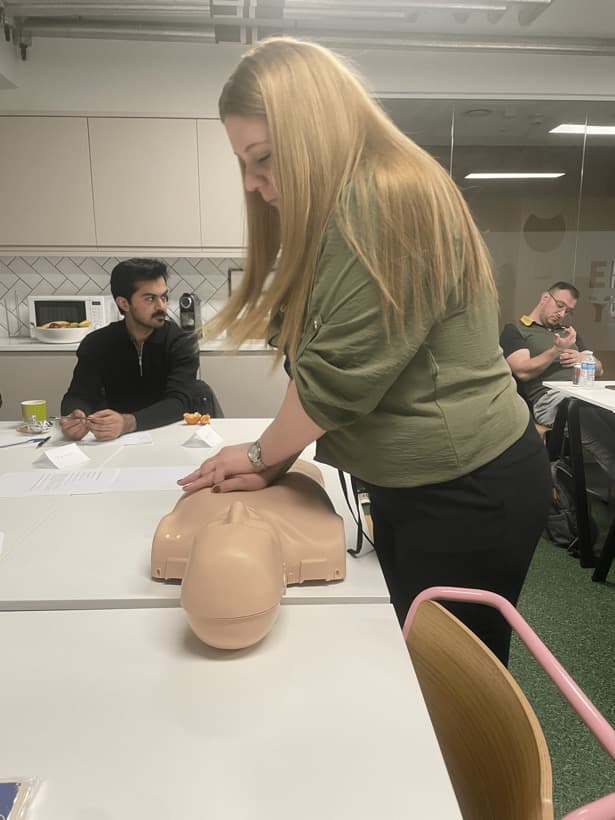 A delegate practising chest compressions on a manikin