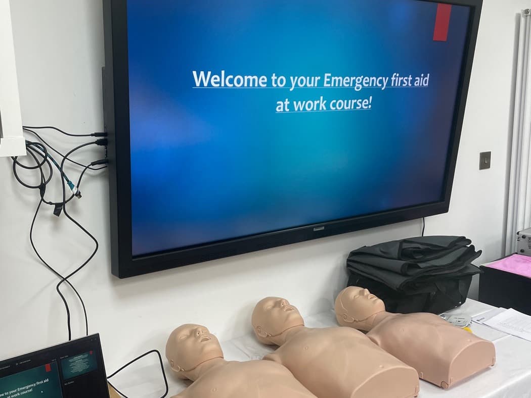 Training manikins and course slides set up in a client meeting room